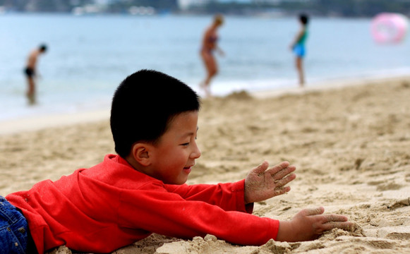 海滩上耍沙的儿童
