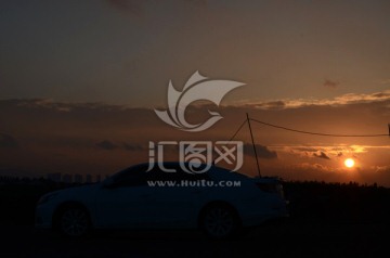 夕阳下行驶的汽车