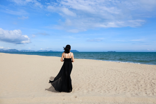 三亚海边穿黑色长裙的女人背影