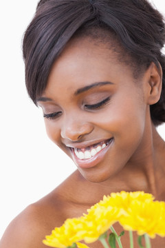女人微笑着捧着黄色的花