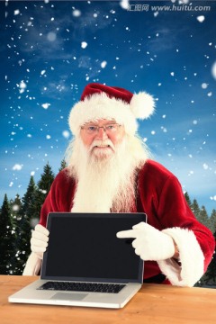 圣诞老人展示笔记本的复合图像