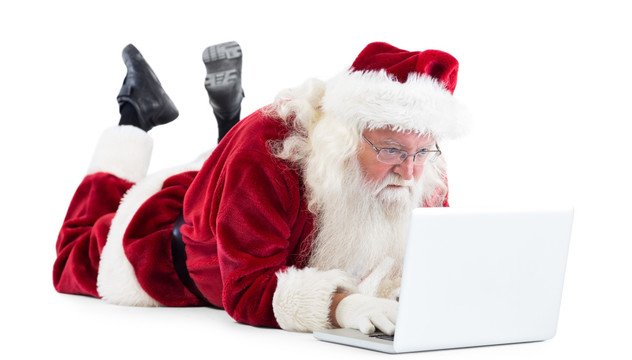 趴地上使用笔记本电脑的圣诞老人
