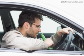 在开车时喝酒的男人