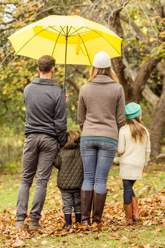 撑着雨伞在公园里家人