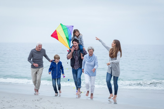 在海边放风筝的大家庭