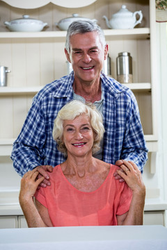 微笑的老夫妇坐在厨房里