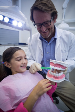牙医向病人展示如何刷牙