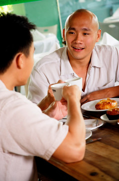 两个男人在咖啡馆吃饭