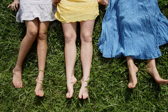 三个少女躺在草地上