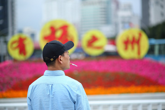 大花圃前抽烟的男人