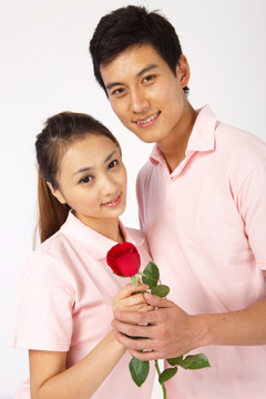 年轻情侣拿着玫瑰花