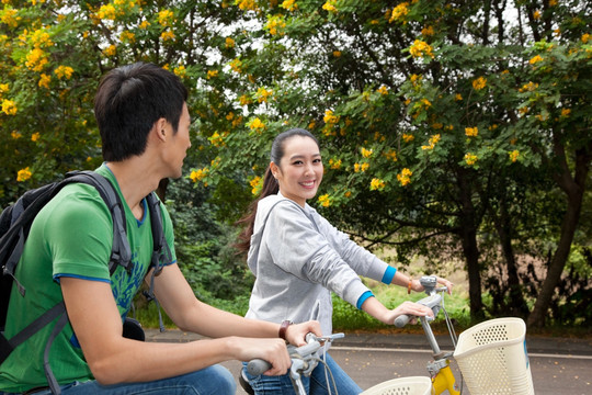 年轻大学生在校园里骑车