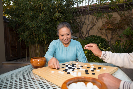 老夫妻在庭院里下棋