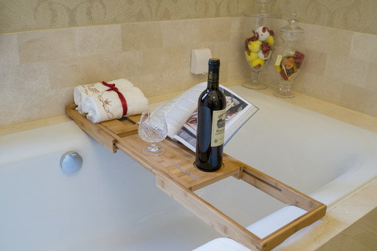 浴缸架子上的红酒与毛巾