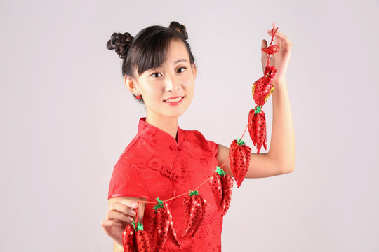 拿著紅辣椒掛飾的可愛女人