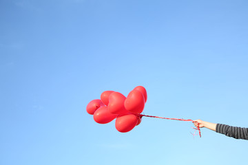 手拿着飘在空中的红气球