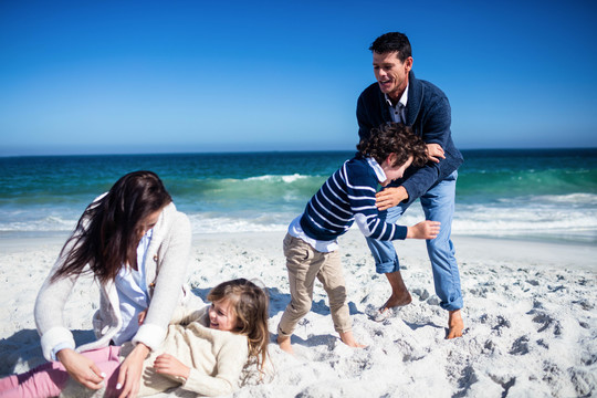 可爱的一家人在沙滩上玩