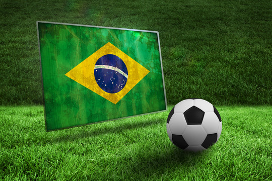 草地上黑白足球与巴西国旗