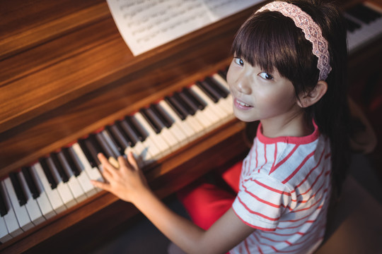 练钢琴的微笑女孩