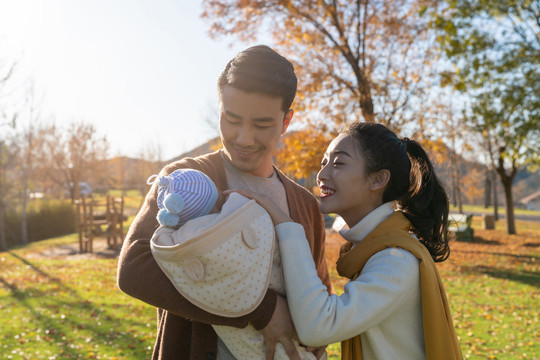 年轻夫妻抱着宝宝散步