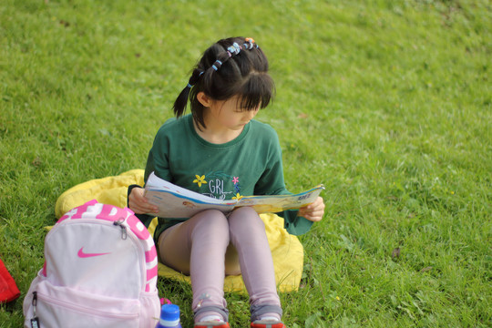 在草地上看书的女孩