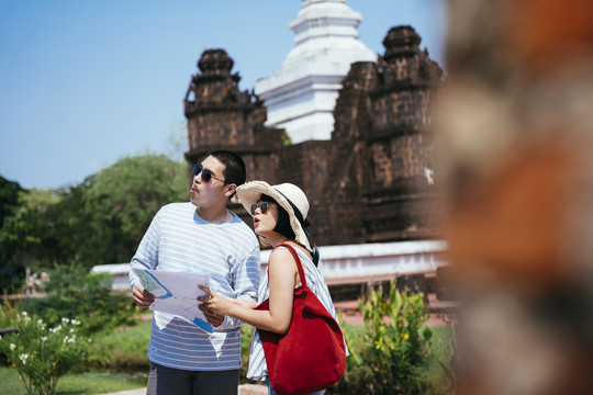 亚泰旅游夫妇使用地图和智能手机在泰国古城旅游。