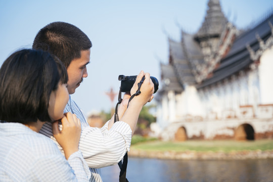 一对亚泰人喜欢用相机一起拍摄佛寺。