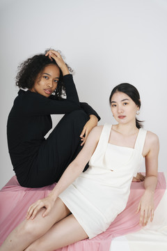 亚洲白衣女人和非洲黑衣女人的时尚写真。