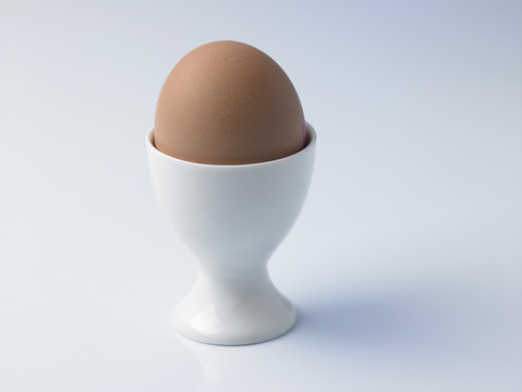 白色背景上的蛋杯中的蛋
