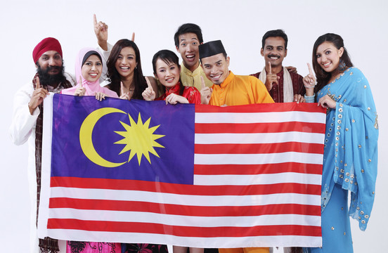 手持马来西亚国旗的多种族男女团体