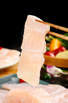 筷子夹着新鲜巴沙鱼片