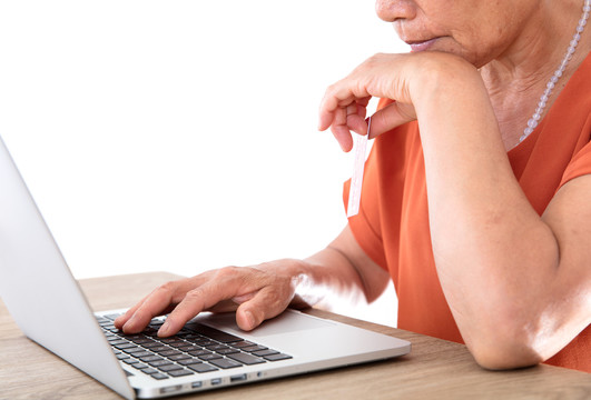 中年妇女正使用笔记本电脑网购