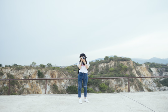年轻的亚泰黑头发旅行家女子用相机拍照。春布里。科罗拉多大峡谷
