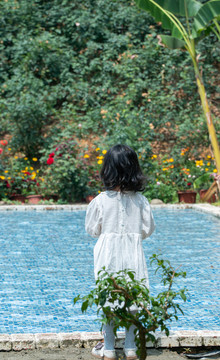 亚洲小女孩正面对着游泳池