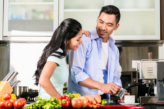 亚洲夫妇，男人和女人，一起在厨房做饭和煮咖啡