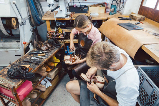 女鞋匠和男鞋匠在车间里一起工作