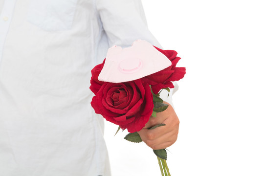 一束玫瑰花及花上一个口罩