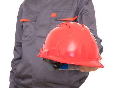 建筑工人手里的红色安全帽