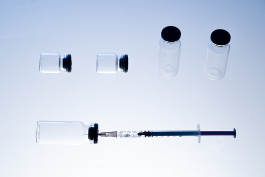白色背景下的注射器和疫苗瓶