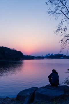 傍晚夕阳下湖边的背影