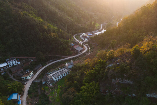 航拍山区乡村夕阳下的道路