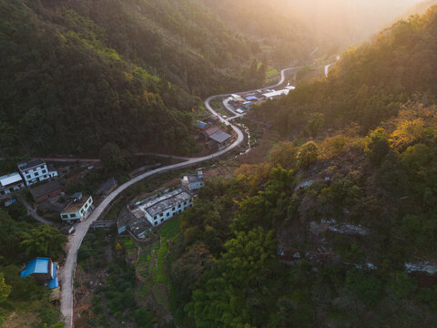 航拍山区乡村夕阳下的道路