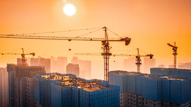 夕阳下城市建组施工吊机