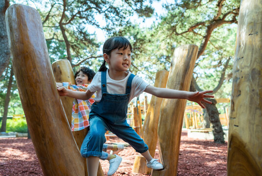 两个小孩子一起走木桩