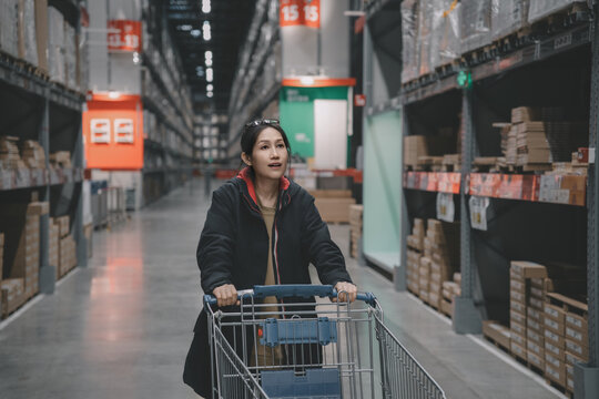 商场推着购物车挑选商品的女性