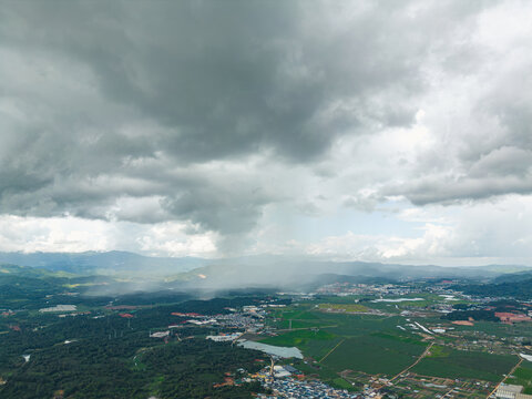 航拍烏云暴雨下的勐海縣田園風光