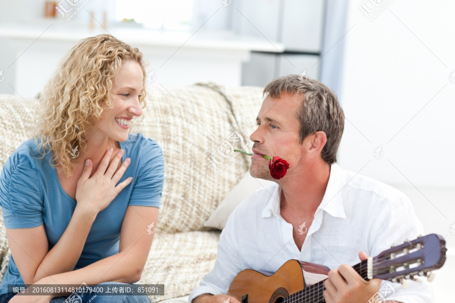 浪漫男人在家里为妻子弹吉他