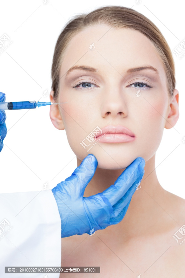 外科医生在女人的脸部上打针