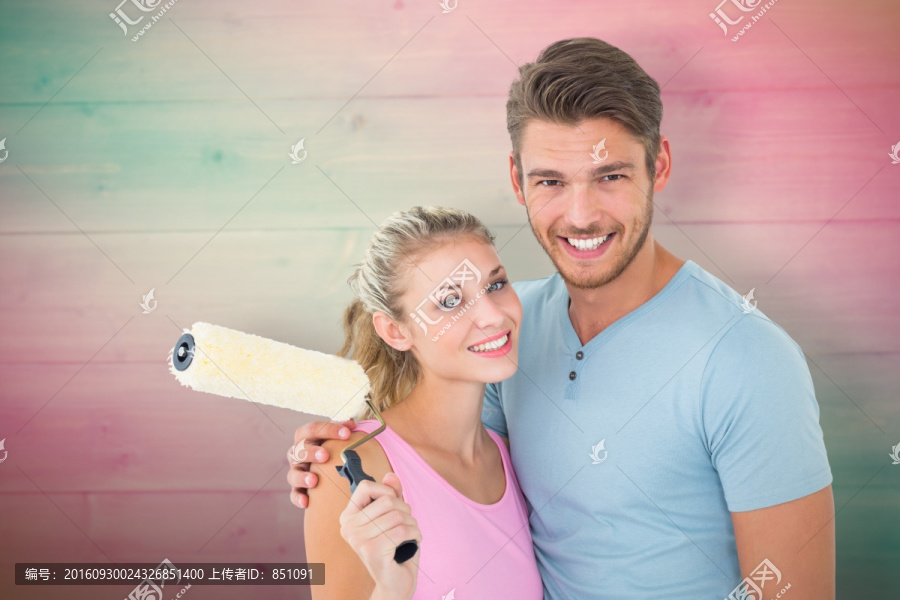 拿著粉刷微笑著的夫婦