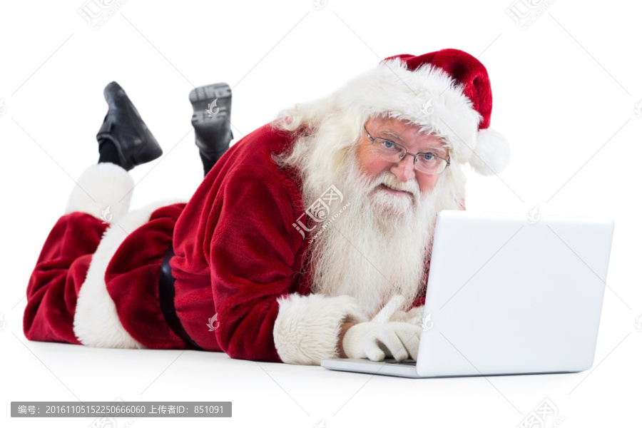 趴地上使用笔记本电脑的圣诞老人